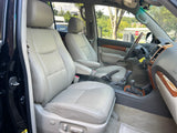 Spacious car interior with light leather seats, wood trim, and dashboard. Ready for an adventure or part of your RV rental fleet.