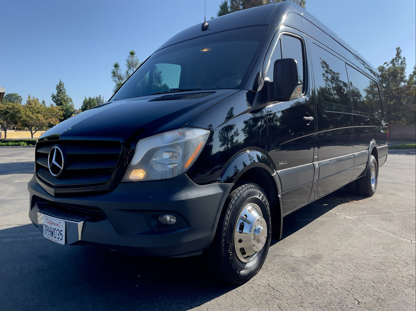 Front view of a black Mercedes-Benz Sprinter van, ideal for an rv rental or luxury group travel, parked outdoors. — photo 18