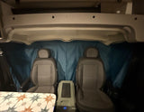 See inside a typical RV rental: front seats, privacy curtain, and a cooler. Perfect for your road trip!