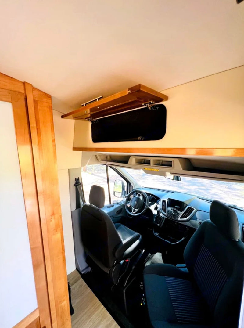  and shower area with curtain.|RV rental interior features comfortable seating — photo 12