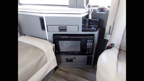  equipped for adventure.|Rugged silver Nissan NV overland van with off-road tires and custom gear