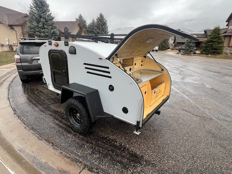 RV rental: Compact grey teardrop camper with open rear galley. Ready for outdoor adventure, perfect for your next trip.