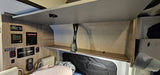 RV rental interior: Overhead cabinet & tech control panel with gauges/switches.