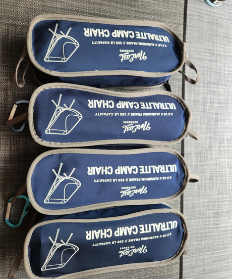 Four dark blue NorEast ultralite camp chairs in bags, weighing 2.5lb each. Ideal portable outdoor gear for an RV rental.