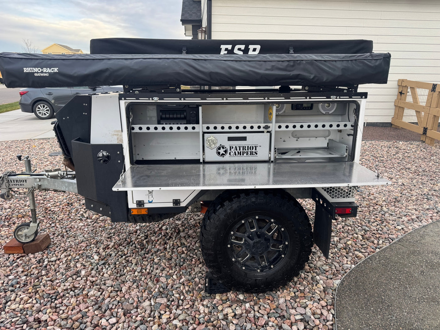 Ready for adventure! This off-road Patriot Campers trailer, great for RV rental, features an open utility bay and Rhino-Rack awning. — photo 13