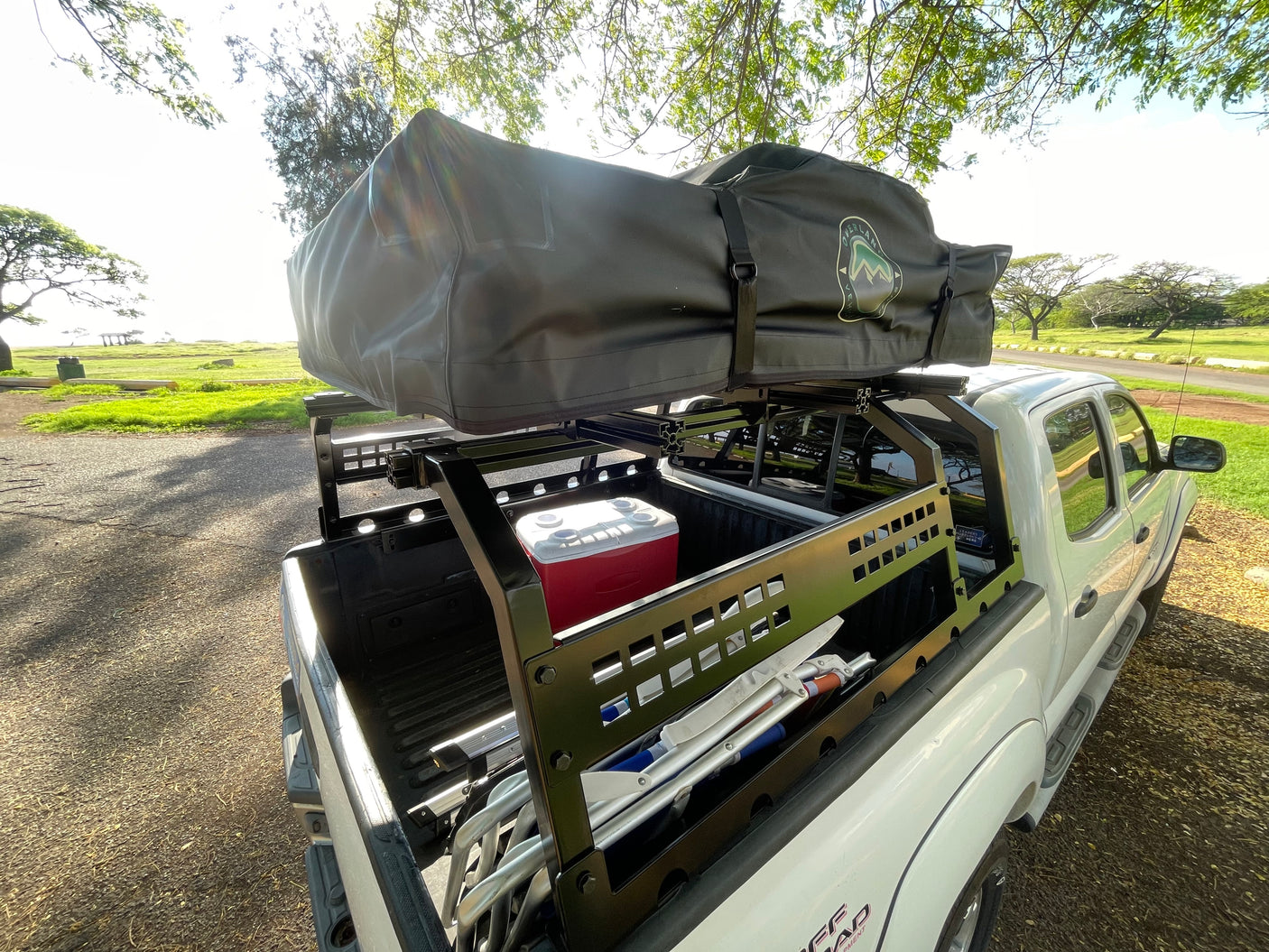 This overland pickup truck, equipped with a rooftop tent & cooler, could be a unique RV rental alternative for camping.