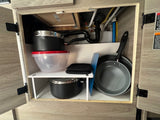 RV rental kitchen cabinet with under-sink compact cookware storage and organization solutions.