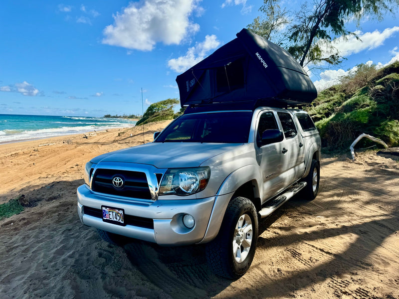 Overland RV rental: Silver Tacoma with iKamper rooftop tent on a sandy Hawaii beach, ocean waves in the background. — photo 5