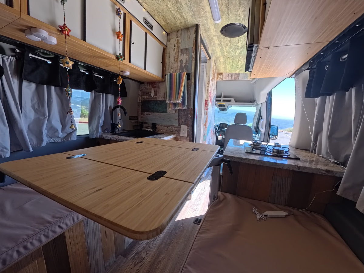  showcasing a custom interior featuring a built-in toilet and colorful decor.|Cozy rv rental interior with kitchen — photo 12