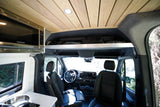 RV rental interior: camper van with wood ceiling, kitchenette, front cabin, and overhead storage.
