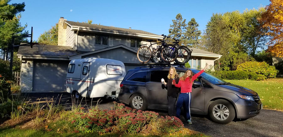  perfect for outdoor camping in a grassy field.|This compact white Scamp travel trailer (RV rental) is parked on grass