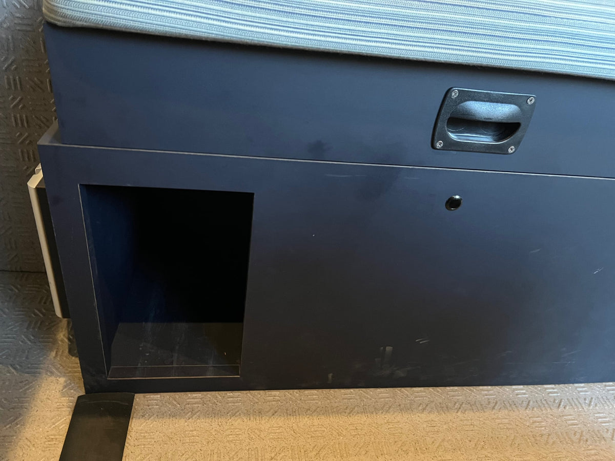  shore power.|RV rental interior: A screened window shows pine trees and a road. Power outlets and a striped cushion are visible.|Rear view of an rv rental camper van — photo 15