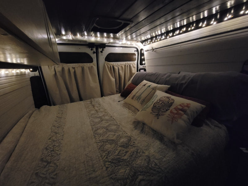  and green cabinets for comfy travels.|RV rental: Camper van interior features a comfy bed — photo 8