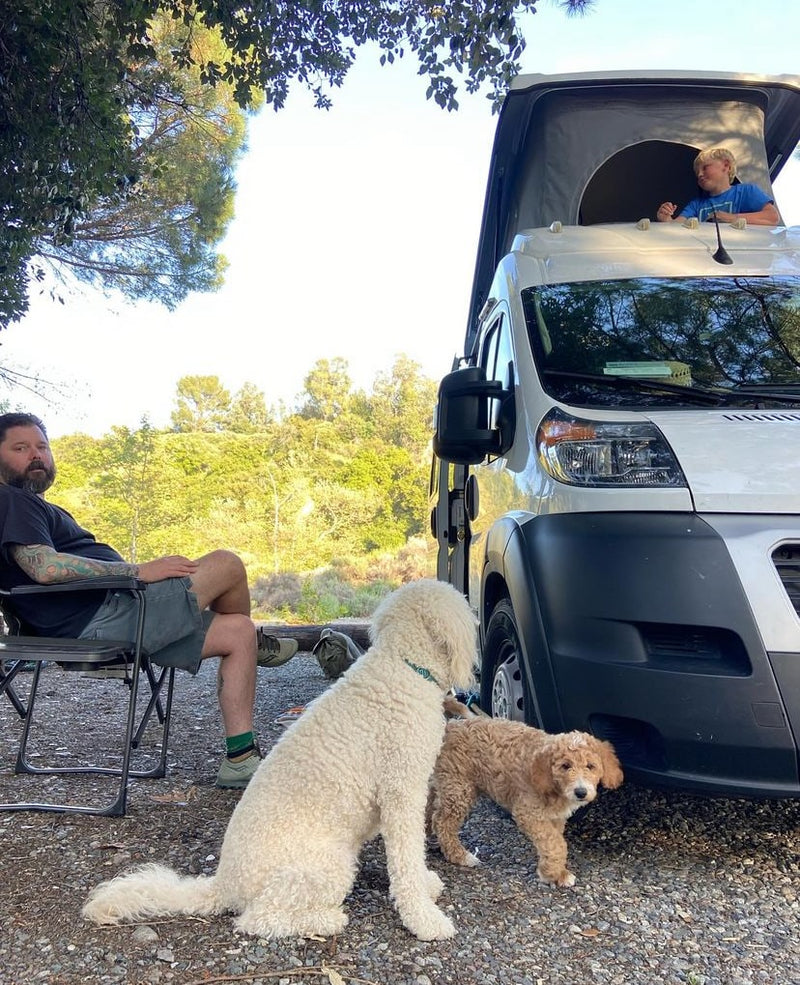  overlooking a snowy landscape.|Smiling boy in waders inside a spacious RV rental. Perfect for family travel & camping adventures.|Family fun & furry friends on an RV rental adventure! A man sits — photo 6