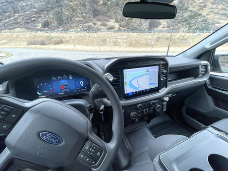 Inside a Ford truck's cabin with a digital dashboard and navigation map, perfect for an rv rental road trip.