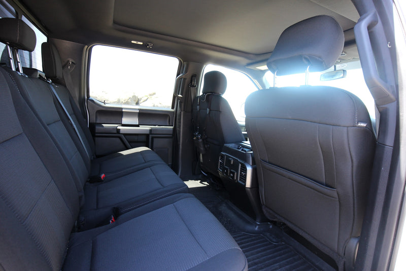 Spacious rear cabin of a truck or SUV, ideal for an RV rental adventure. Black fabric seats, AC vents, and power outlets for passengers. — photo 14