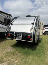 Compact T@B travel trailer, perfect for your next RV rental adventure, parked on grass in Texas.