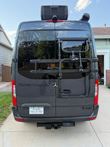 Rear view of a dark gray Mercedes-Benz RV rental with a bike rack, roof AC, and Colorado plates. Ready for the open road.