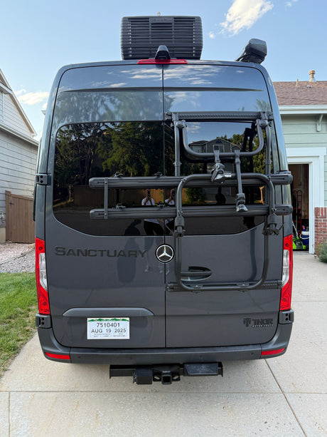Rear view of a dark gray Mercedes-Benz RV rental with a bike rack, roof AC, and Colorado plates. Ready for the open road.