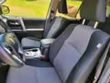Car interior with gray/black fabric seats, steering wheel, and console, seen from driver's side. Ideal for your RV rental trip.