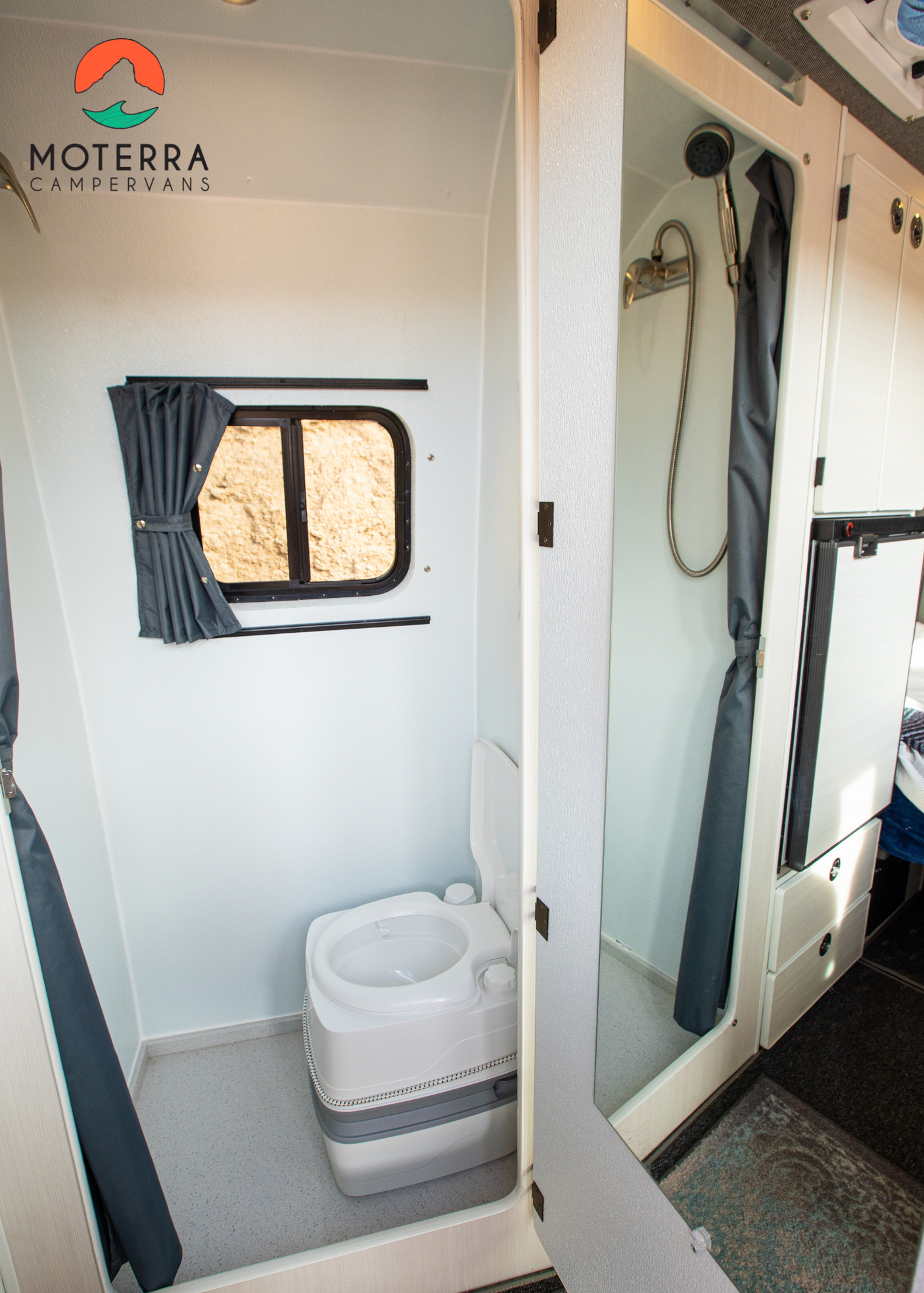 RV rental interior: Compact bathroom with a portable toilet & shower. Perfect for campervan travel.