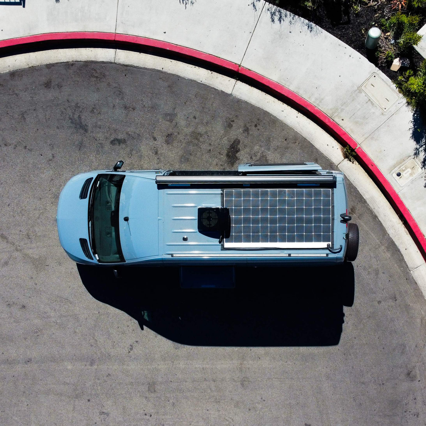  parked with an ocean view under a clear sky.|This blue camper van rv rental — photo 2