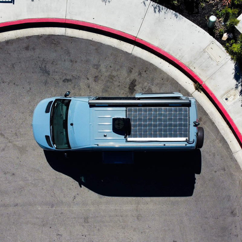  parked with an ocean view under a clear sky.|This blue camper van rv rental — photo 2