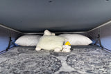 Cozy RV rental sleeping area with soft pillows and cute plushies for a comfortable night's sleep.