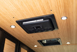 RV rental interior ceiling featuring an AVELIT climate control unit, bright LED lights, and a roof vent for passenger comfort.