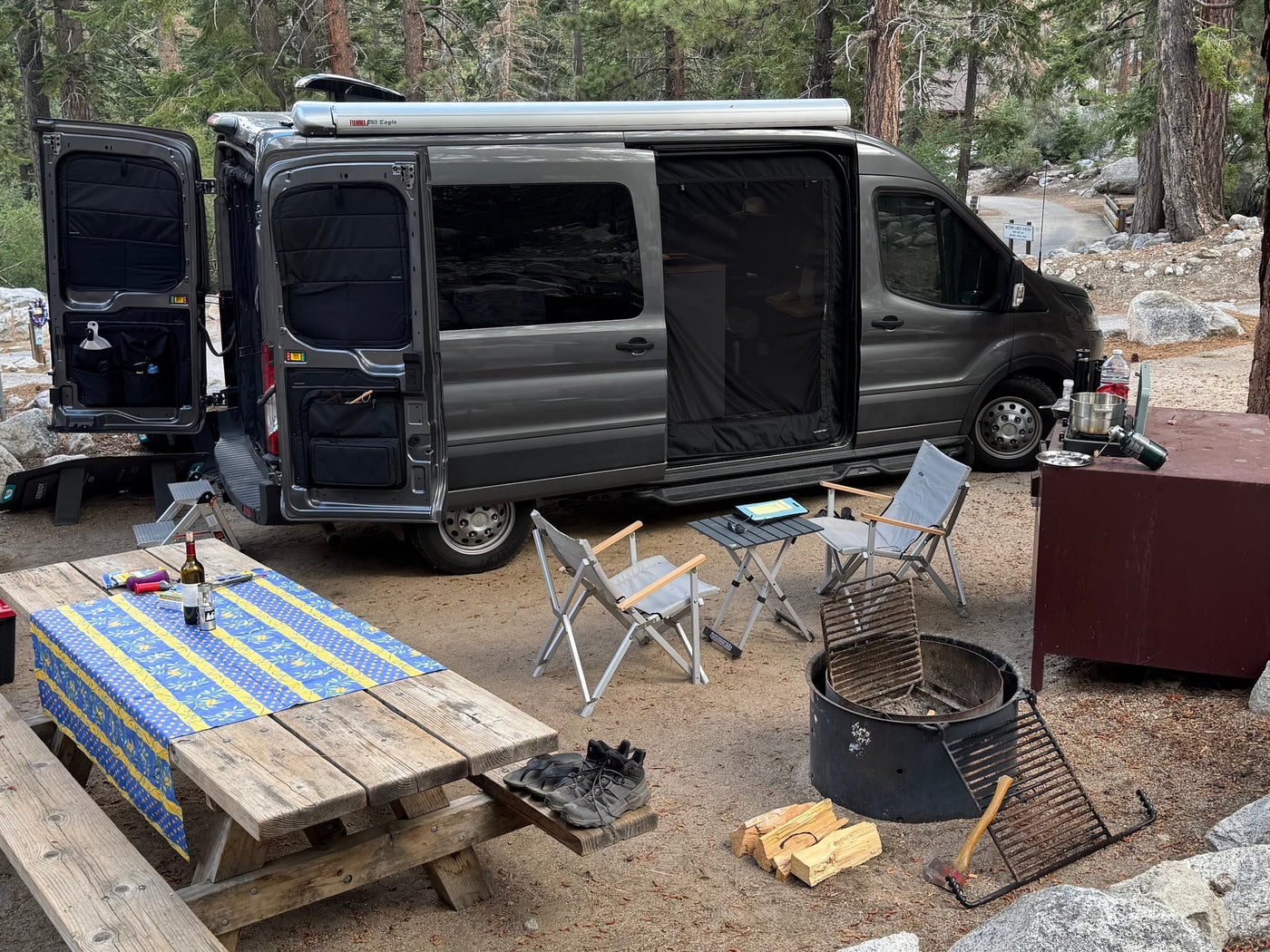  and a fire pit are ready for outdoor adventure.|This rv rental campervan reveals a rear bed — photo 3