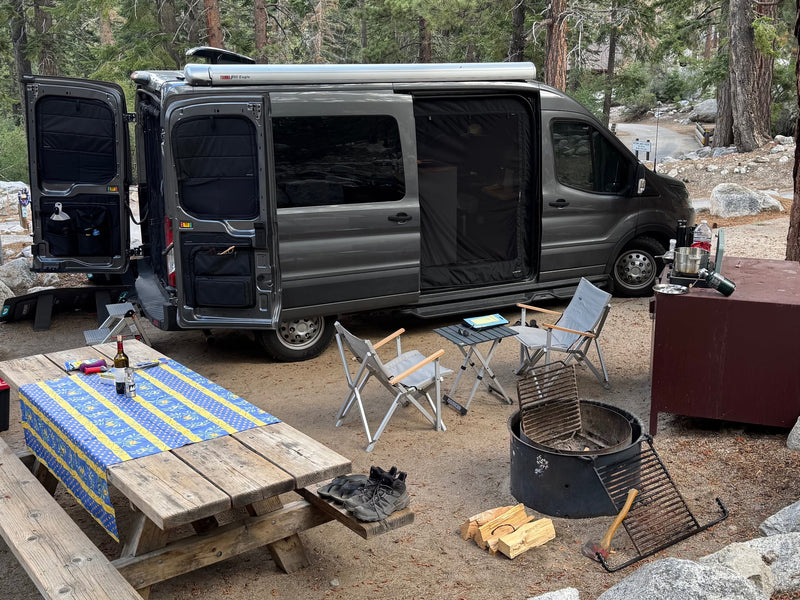  and a fire pit are ready for outdoor adventure.|This rv rental campervan reveals a rear bed — photo 3
