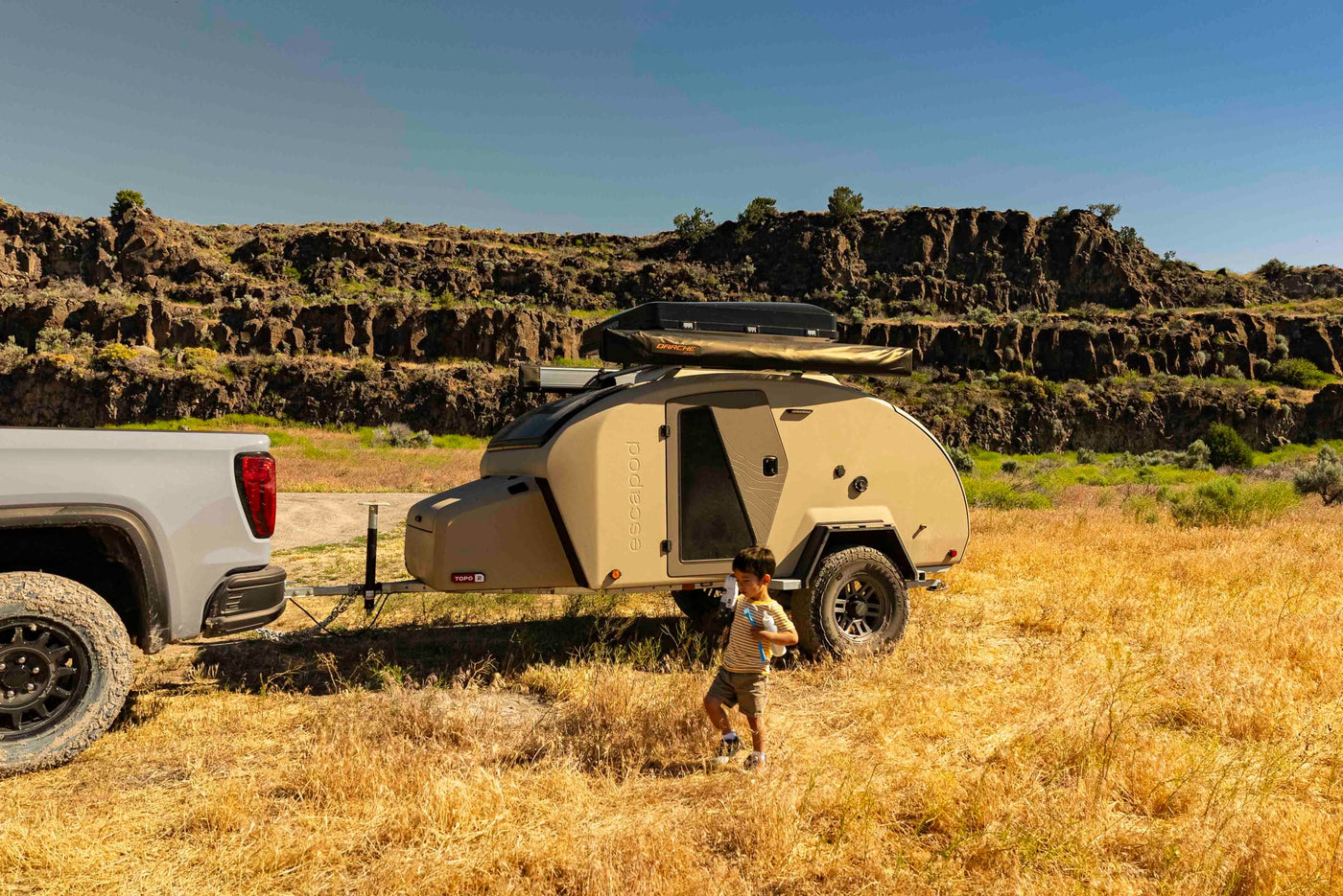  rocky landscapes.|Enjoy your RV rental adventure! A child by an Escapapod camper trailer & truck in a sunny — photo 8