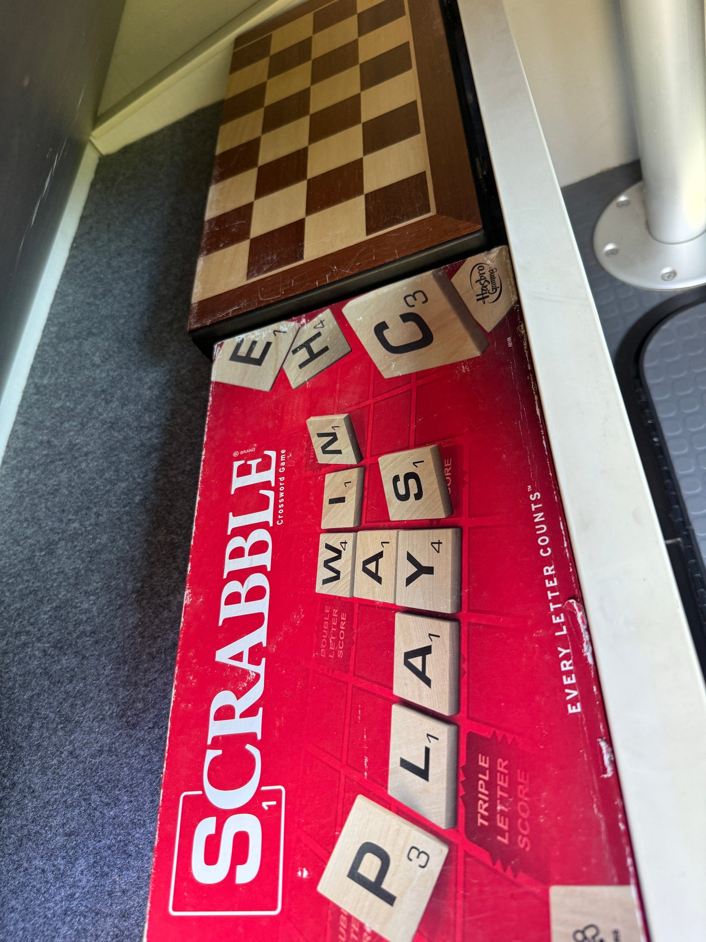 Scrabble and a chessboard inside an RV rental, offering classic board game fun for your road trip adventures.