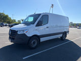 White electric Mercedes-Benz Sprinter van with specialized roof gear in a sunny parking lot. Versatile for commercial use or an rv rental.