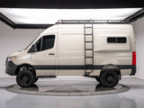 Side view of a tan Mercedes Sprinter rv rental camper van with a roof rack and ladder, on a studio turntable.