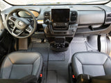Spacious rv rental cockpit featuring a Ram steering wheel, large touchscreen, and comfy seats with durable floor mats.