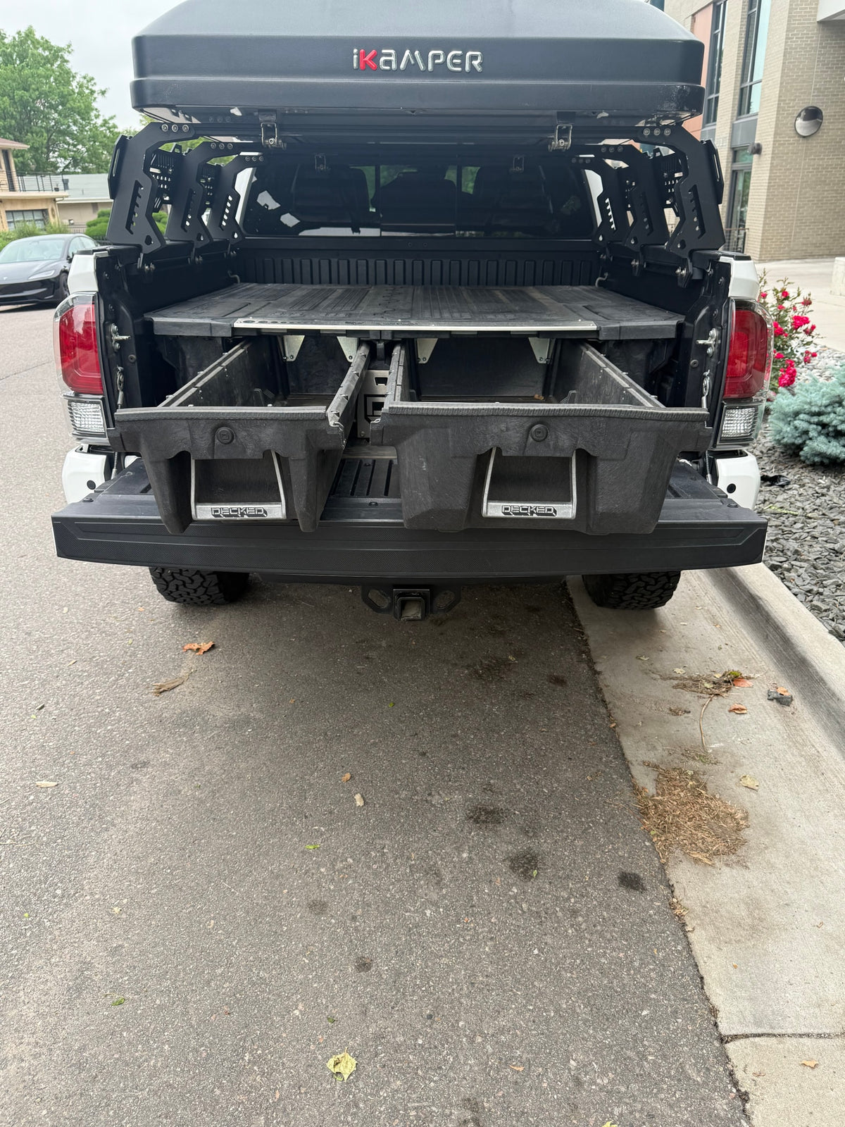 Rear of pickup with iKAMPER rooftop tent & DECKED bed storage. Great for overlanding, an RV rental alternative. — photo 12