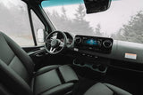 Modern Mercedes-Benz van interior, ideal for an RV rental. Spacious driver's cabin with dashboard, screen, and comfortable seats.