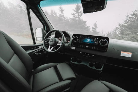 Modern Mercedes-Benz van interior, ideal for an RV rental. Spacious driver's cabin with dashboard, screen, and comfortable seats.