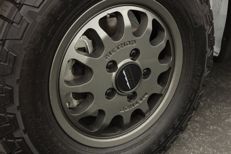 Close-up of a rugged Cooper Discoverer tire and Method wheel with Brembo brakes, ideal for an RV rental adventure.