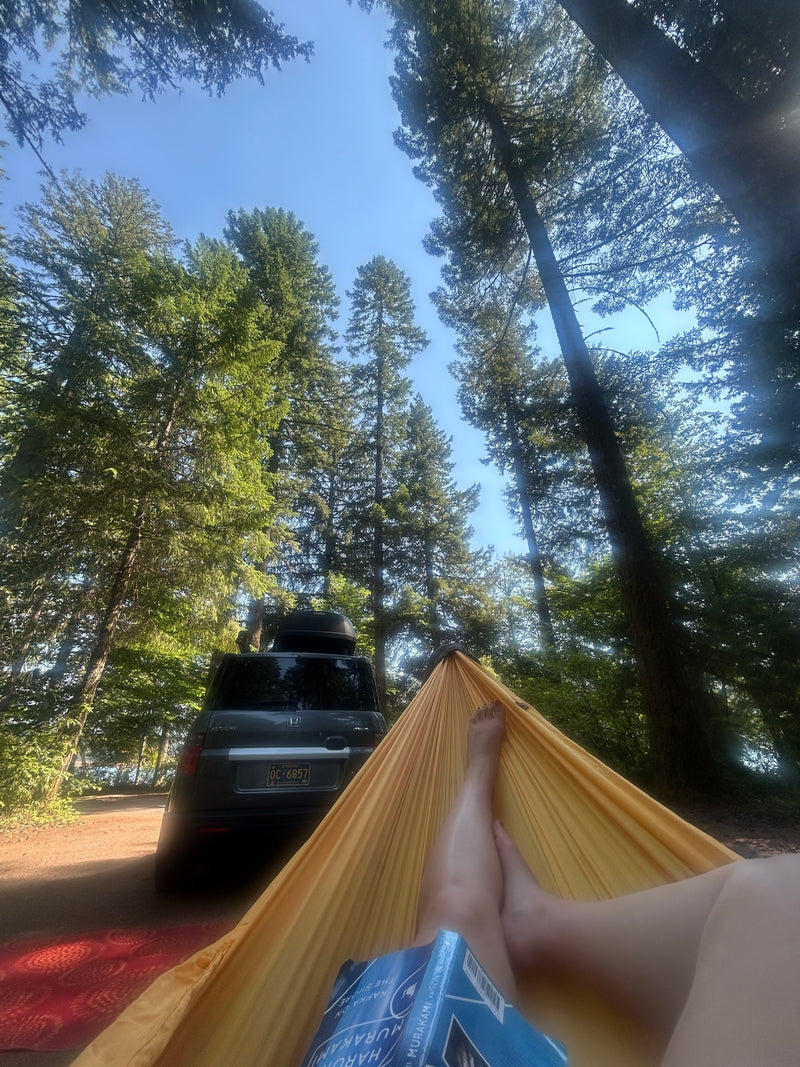 Hammock chill with a book by an SUV in the forest. Enjoying nature's peace; no rv rental needed for this camping escape. — photo 10