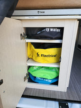 Well-organized storage in an RV rental, featuring labeled bags for water, electrical, & accessories. Includes a Thor step stool.