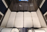 RV rental: View of a luxurious sleeping area with four quilted white mattress sections inside the cabin.