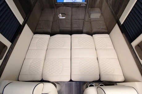 RV rental: View of a luxurious sleeping area with four quilted white mattress sections inside the cabin.