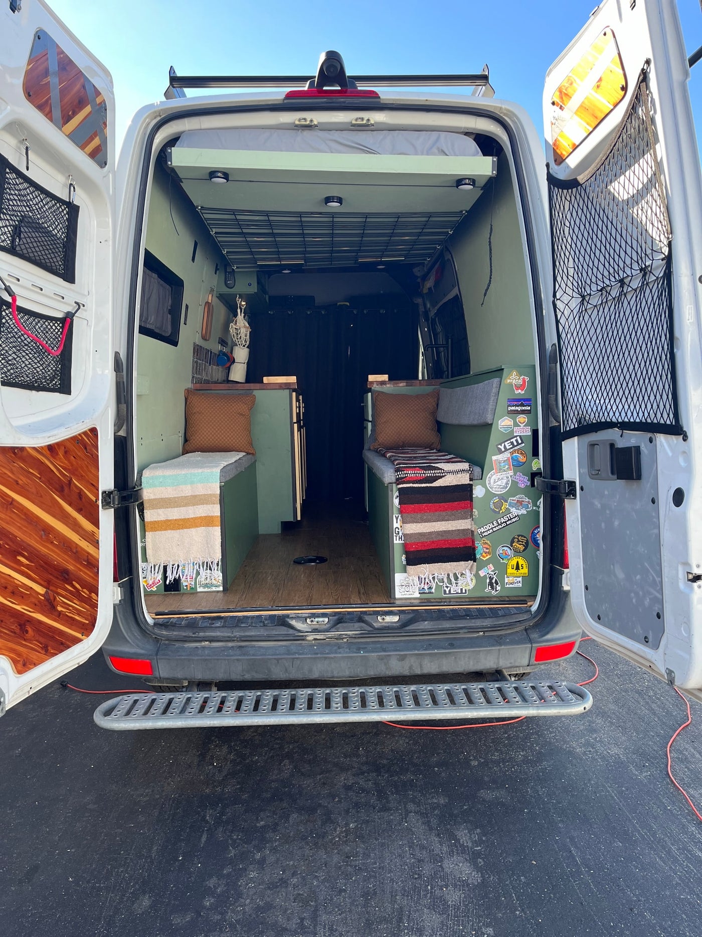  perfect for national park camping.|Rear view of a custom green camper van interior — photo 2
