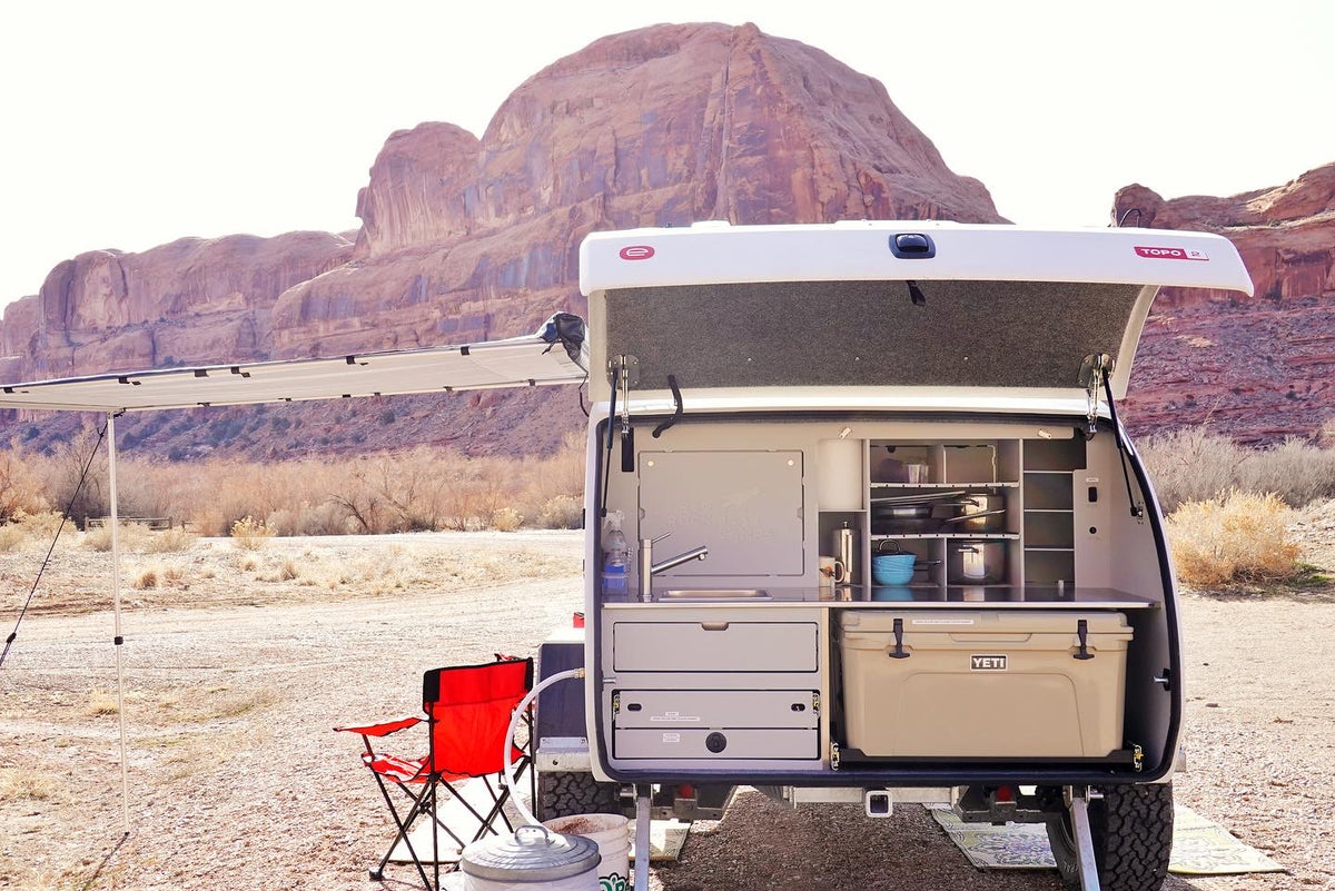 Explore off-grid! This RV rental teardrop camper boasts an outdoor kitchen with sink & cooler, ideal for desert adventures. — photo 14