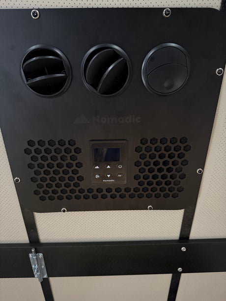 RV rental interior: A Nomadic AC unit features three vents, a digital display (78°F), and controls on a black panel.
