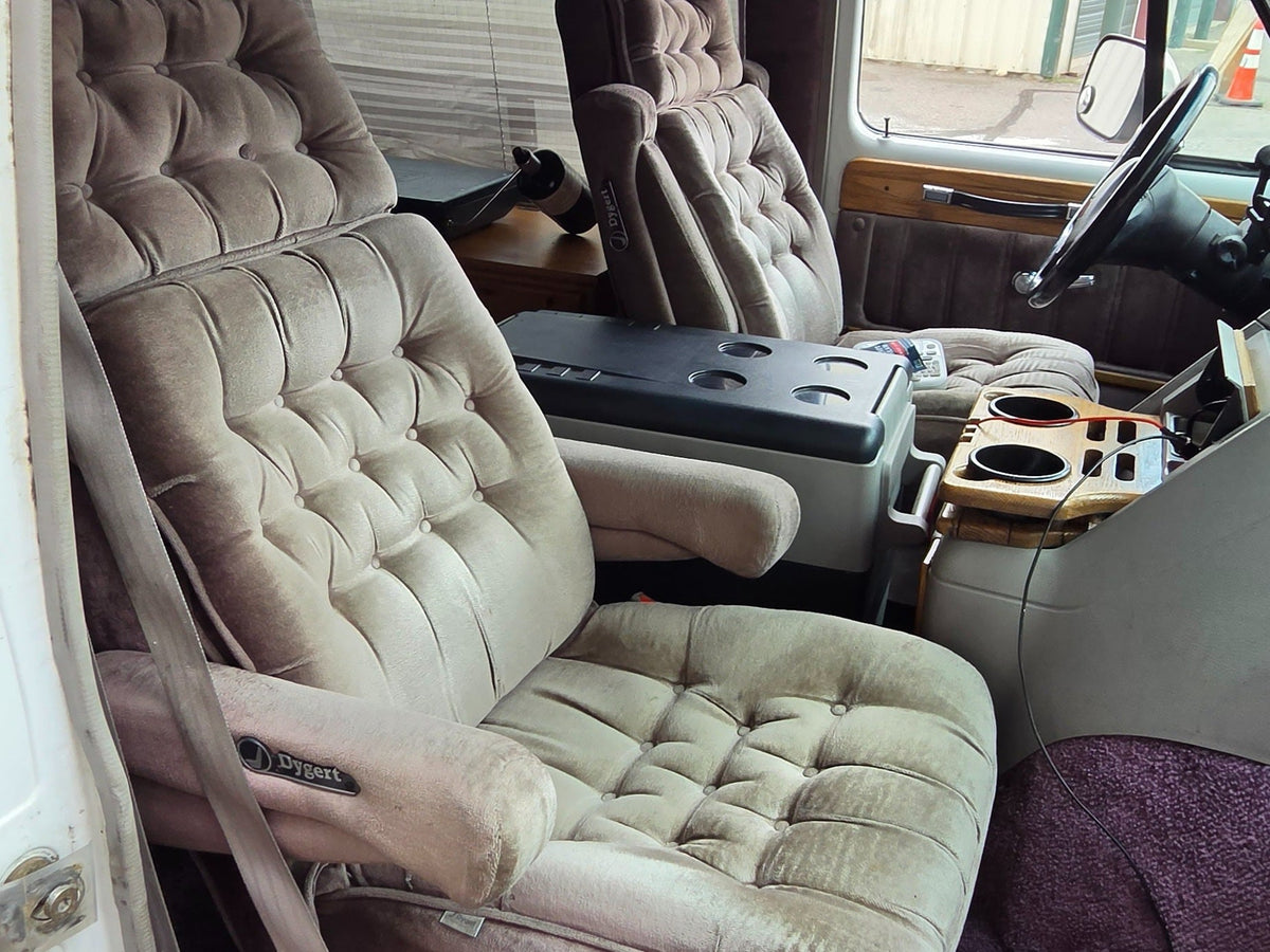  parked curbside next to a reflective building.|Plush — photo 4