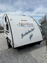 White Bushwhacker Plus travel trailer, available for rv rental from Joy Ride RV Rental. Ready for your next adventure!