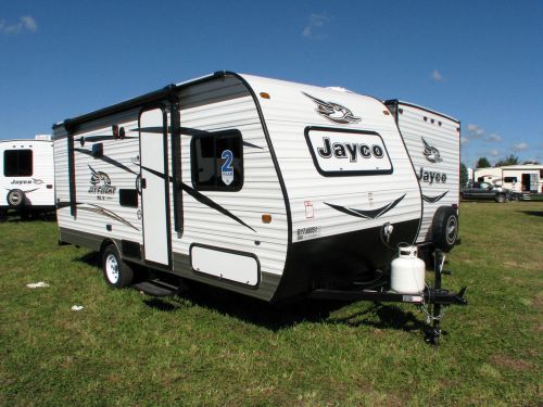 White Jayco travel trailer on green grass — photo 1